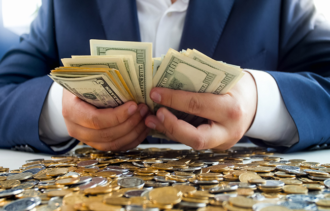 Closeup image of rich wealthy businessman cointing big stack of money