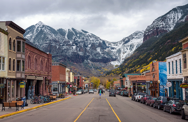 Telluride, Colorado, USA - October 14, 2018 : Colorado Avenue in Telluride facing the San Joan Mountains. Telluride is a historic mining town and popular ski resort.