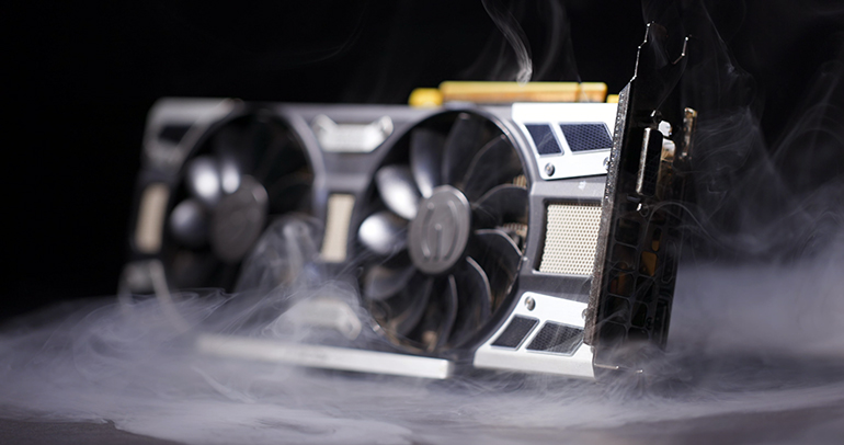 Graphics card with smoke rising and dark background closeup